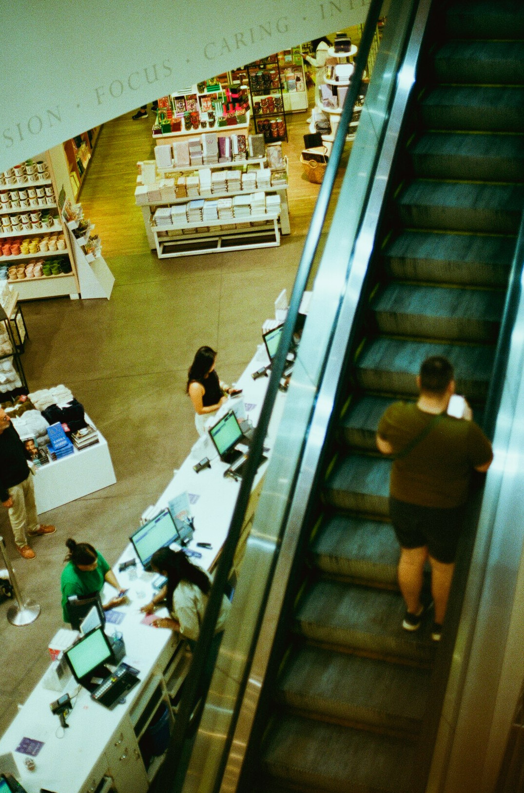 Team analyzing checkout line data on a laptop in a store